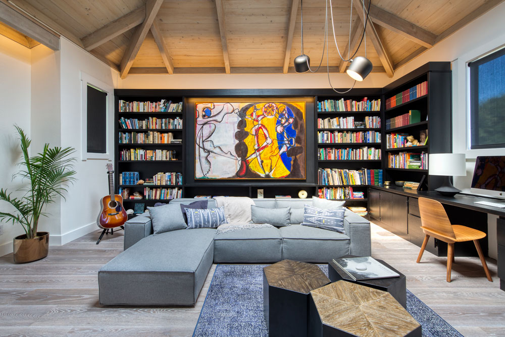 A living room design with bookcases and art